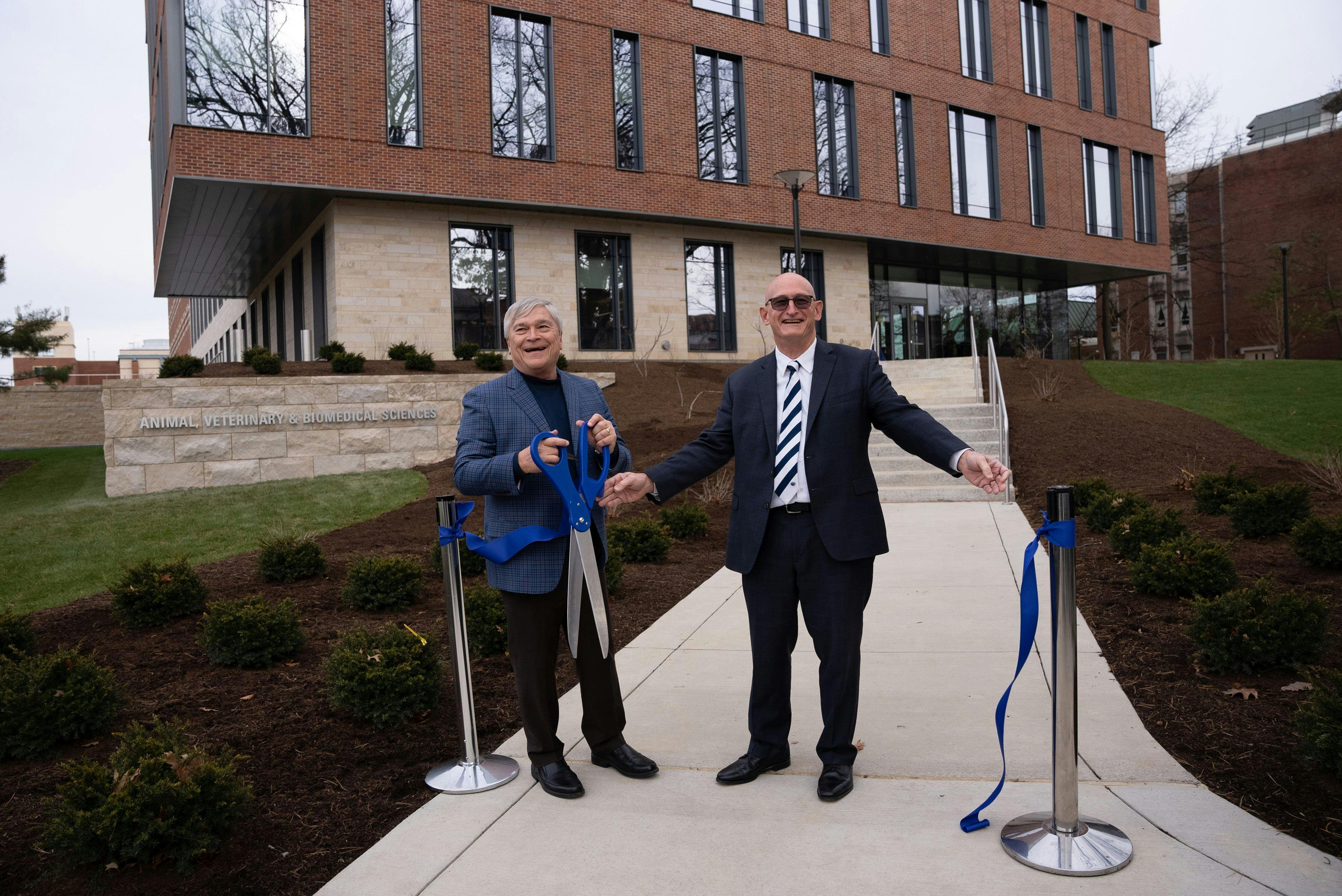 Penn State president, Eric Barron, left, and College of Agricultural Sciences dean Rick Roush share a laugh after cutting the ribbon marking the opening of the Animal, Veterinary and Biomedical Sciences Building (Photo courtesy of Michael Houtz, College of Agricultural Sciences, Penn State). 