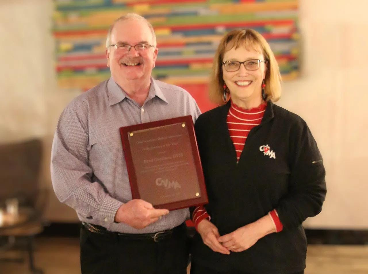 Brad Garrison, DVM, was presented with the 2022 Ohio Veterinarian of the Year Award by Barbara Musolf, DVM. (Photo courtesy of OVMA)