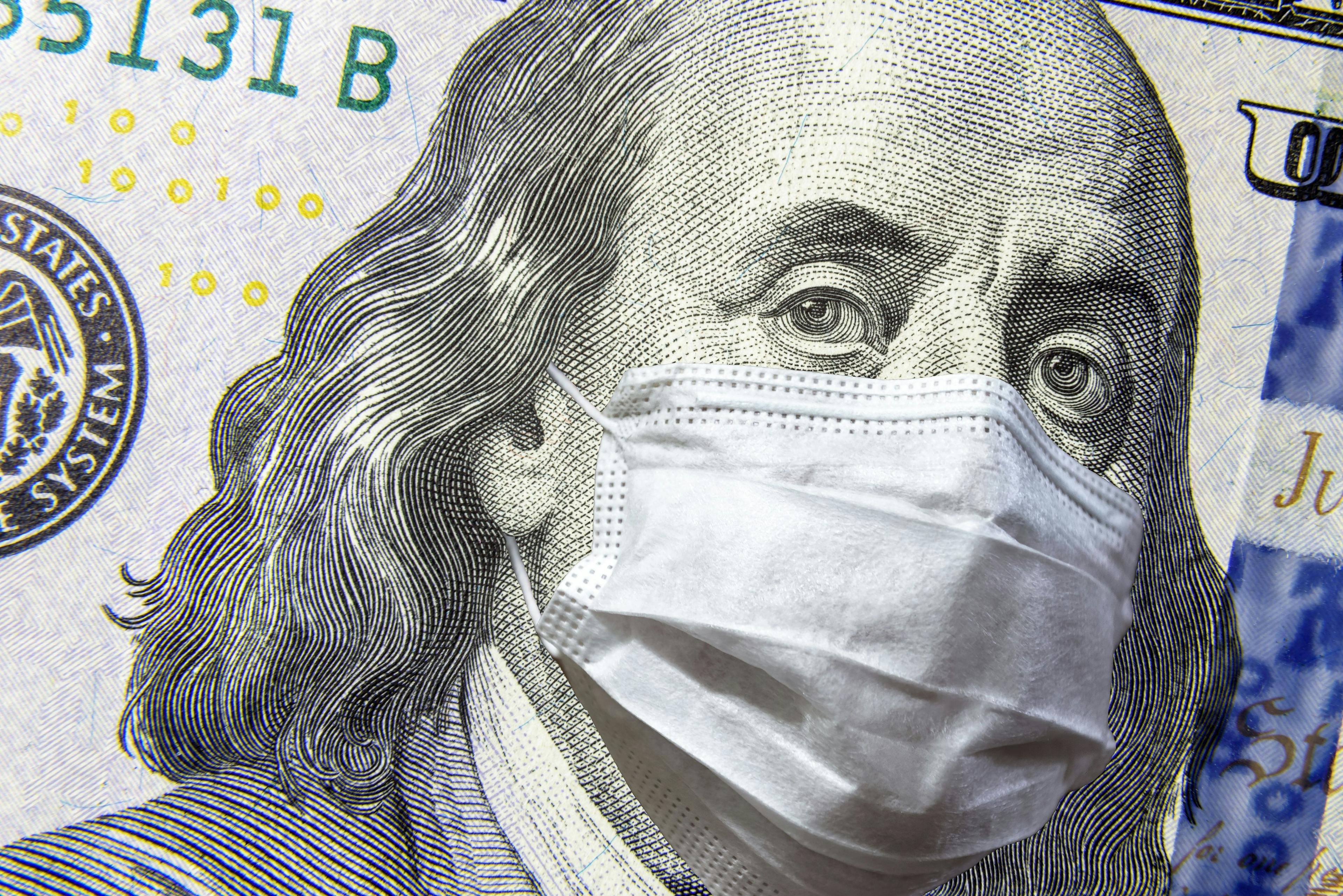 COVID-19 coronavirus in USA, 100 dollar money bill with face mask. COVID-19 affects global stock market.