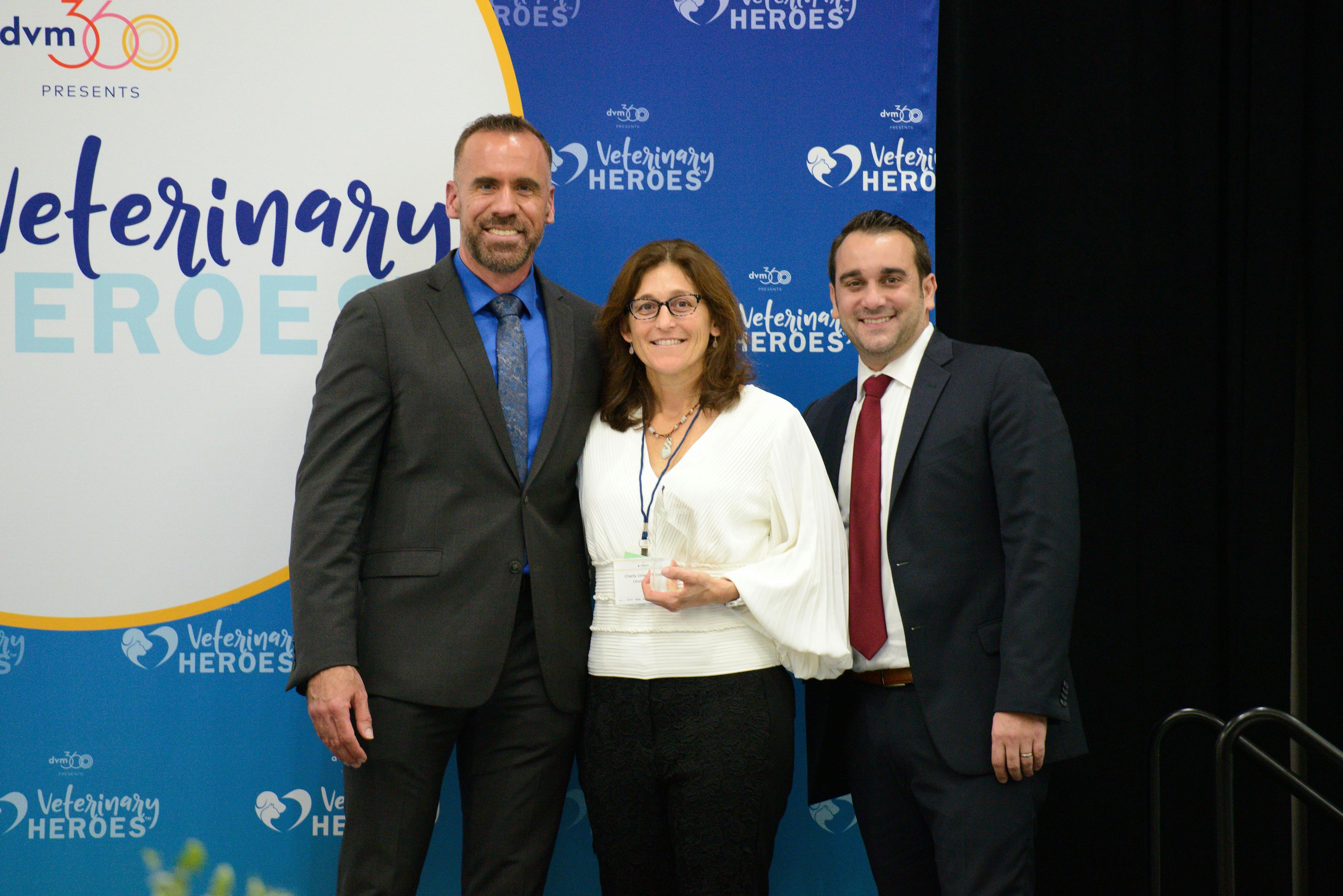 Photo: Jeeheon Cho Photography

Charity J. Uman, MS, DVM (center), receives the Veterinary HeroesTM award for Emergency Medicine from (left) Adam Christman, DVM, MBA, chief veterinary officer for dvm360®, and John Hydrusko, vice president, MultiMedia Animal Care LLC at MJH Life SciencesTM.  