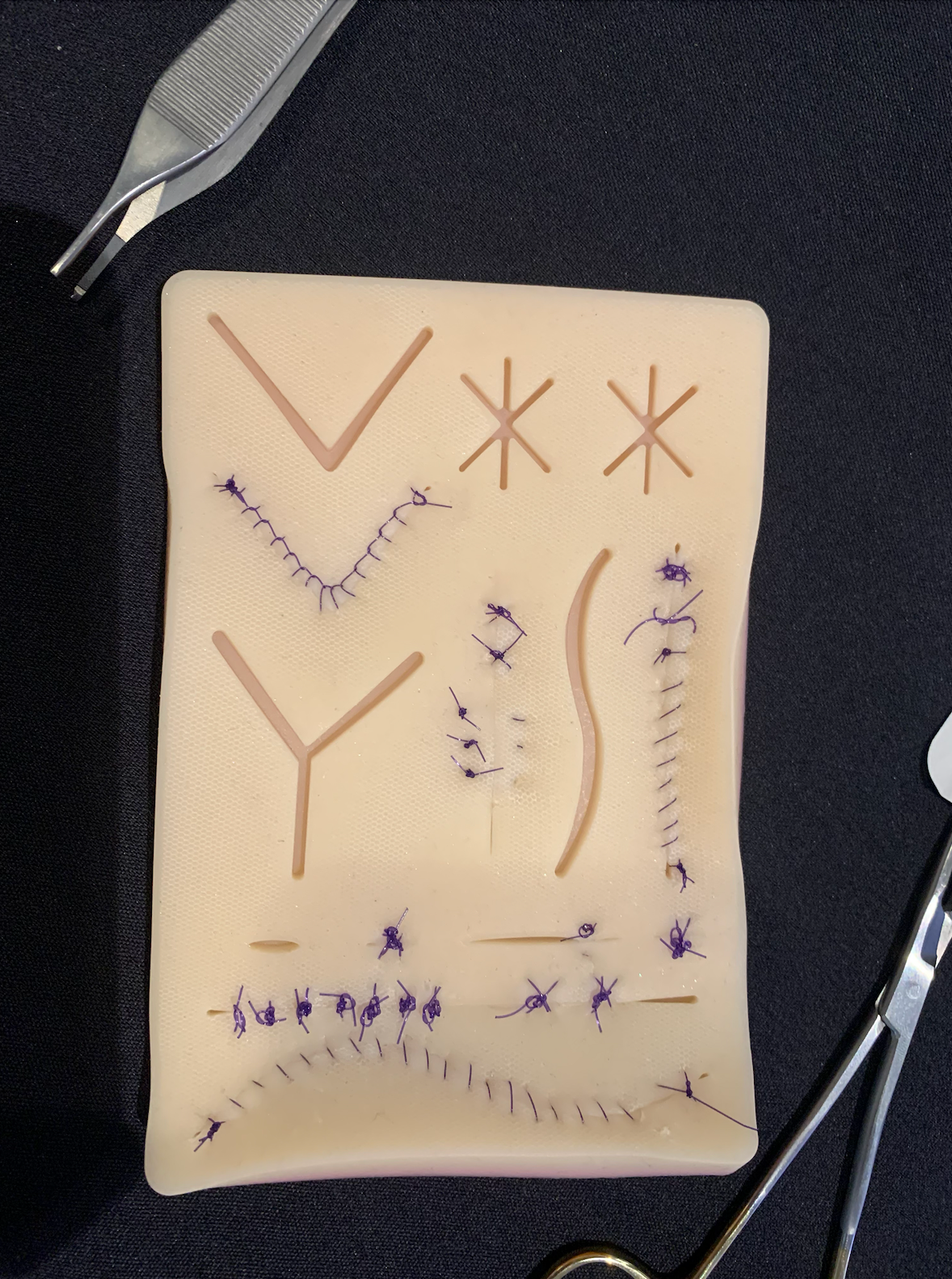 Suture practice on a model skin pad during a suture lab