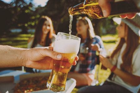 veterinary-cheerful-friends-on-picnic-in-the-park-drinking-beer-450px-shutterstock-482026327.jpg