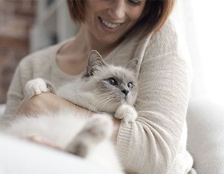 women hugging a cat