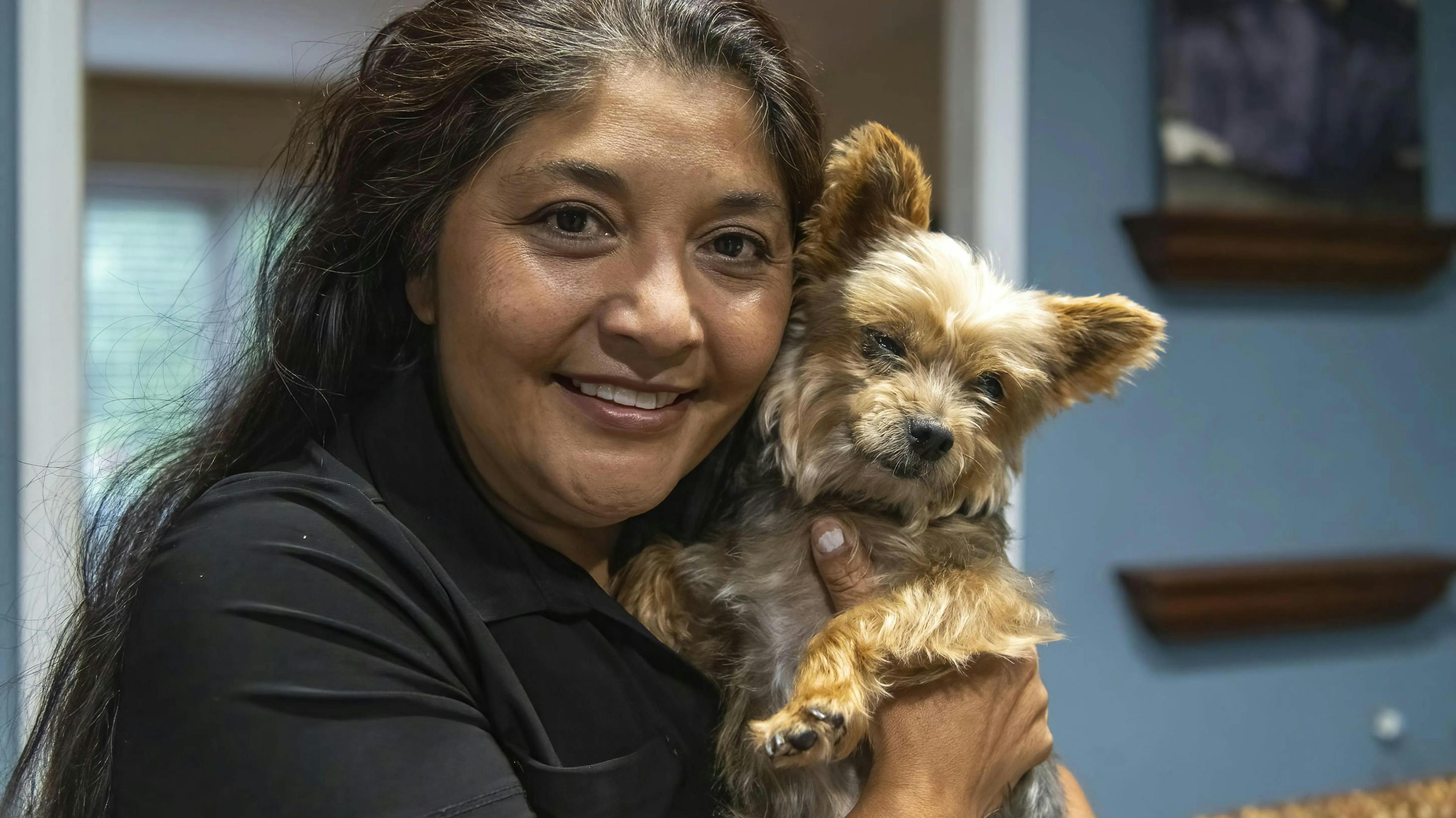 Reina Conner with her dog Lola who was severly injured and separated from the family during the deadly shooting (Photo courtesy of Tyler Pasciak LaRiviere / Sun-Times). 