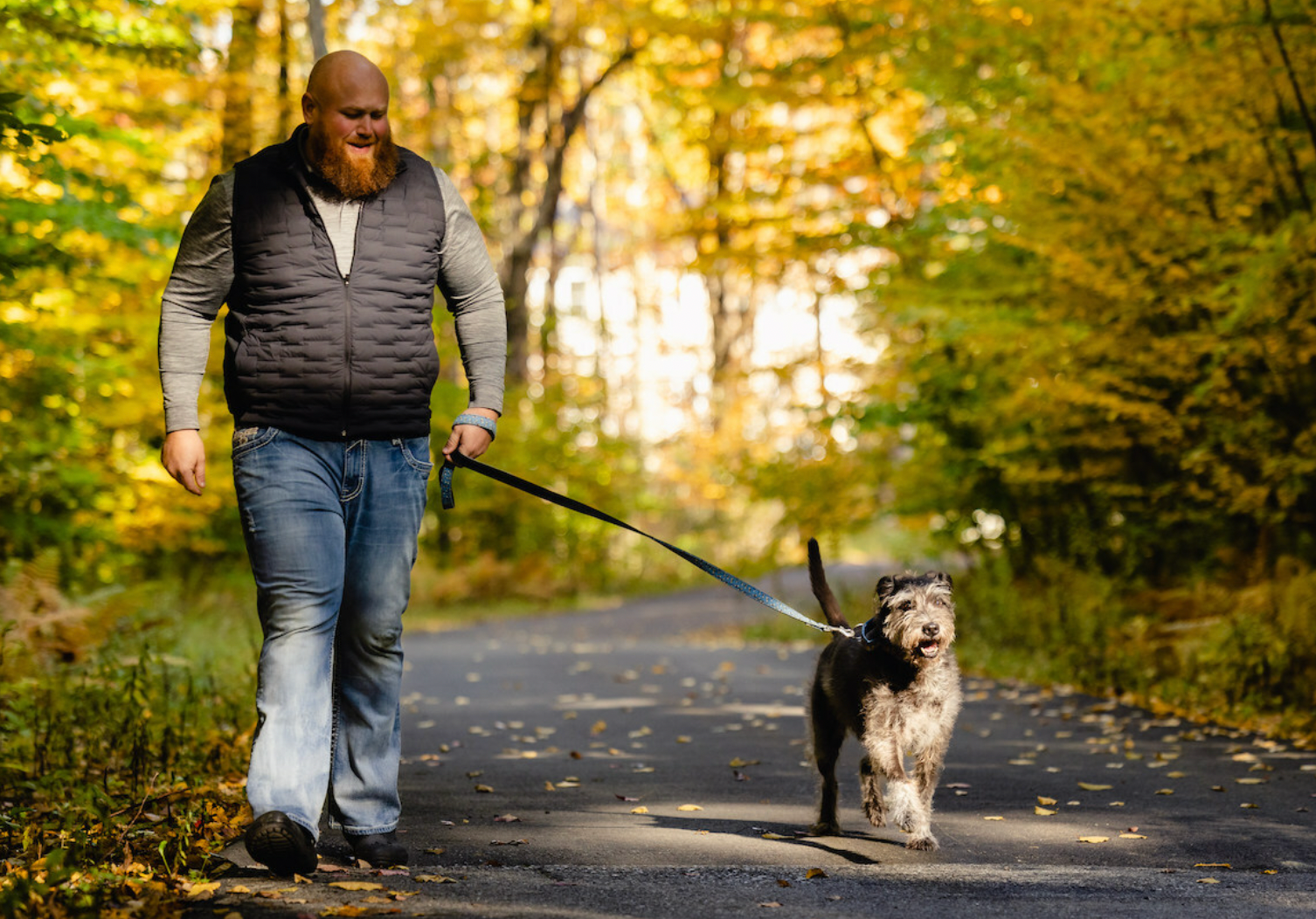 Chris Hughes, founder of the Mr Mo Project, walking with Quinn, a senior rescue dog (Photo courtesy of YuMOVE). 


