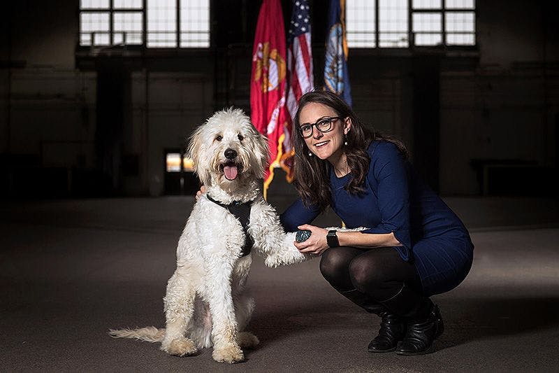 Maggie O'Haire with a service dog.