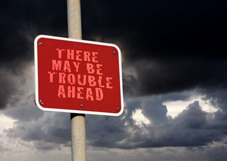 veterinary-trouble-ahead-sign-against-a-dark-cloud-background-shutterstock-98211494-body.jpg