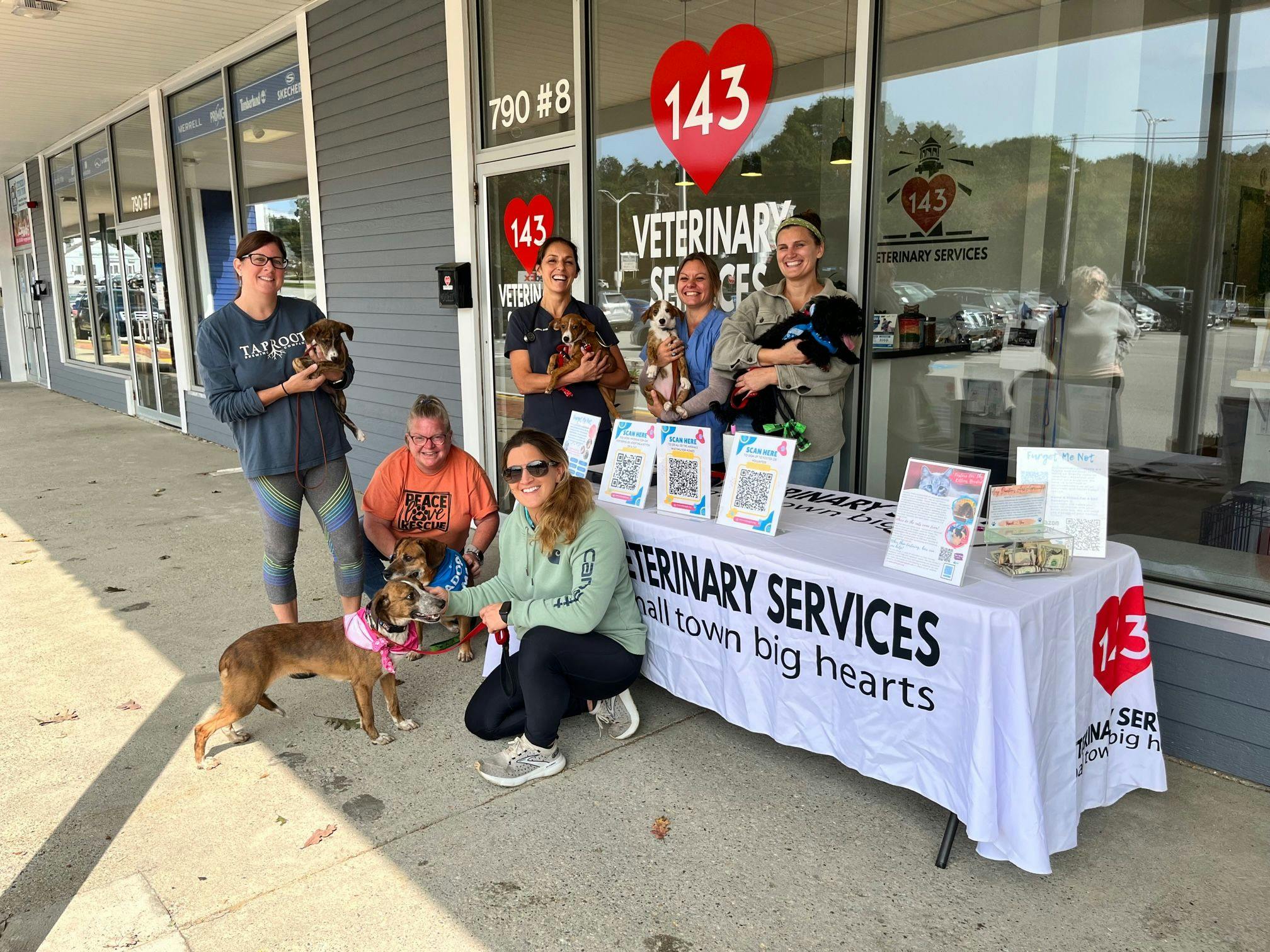 Diana Watkins, DVM, and veterinary technician, Zoe Stoner of 143 Veterinary Services with Furget Me Not executive director Ashley Davis, shelter volunteers, and dogs available for adoption. (Photo courtesy of Watkins Strategies)