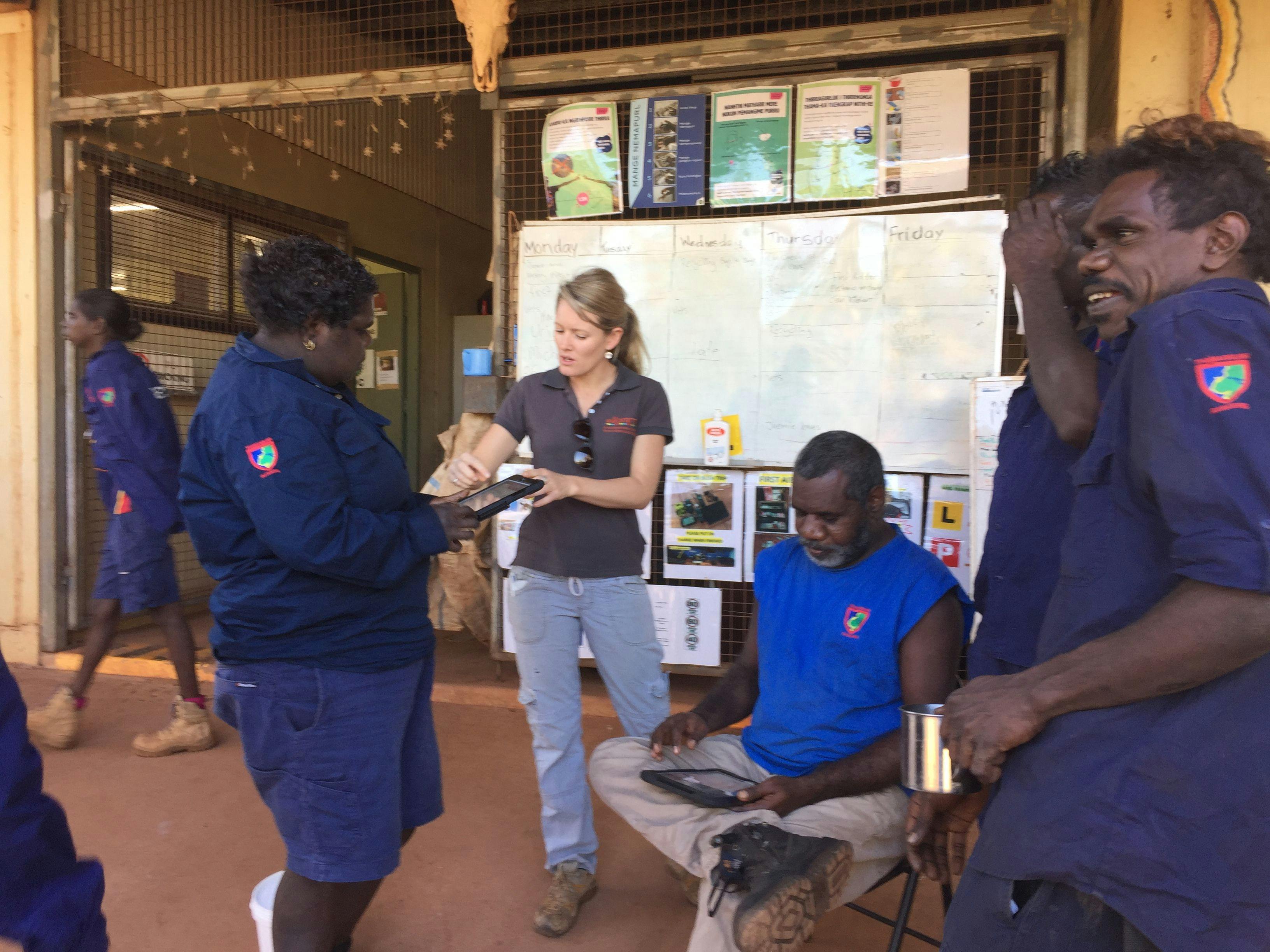 Courtney Falls, AMRRIC education officer, collaborating with the Thamarrurr Rangers at Wadeye training them to use the AMRRIC app (Photo courtesy of the AMRRIC). 