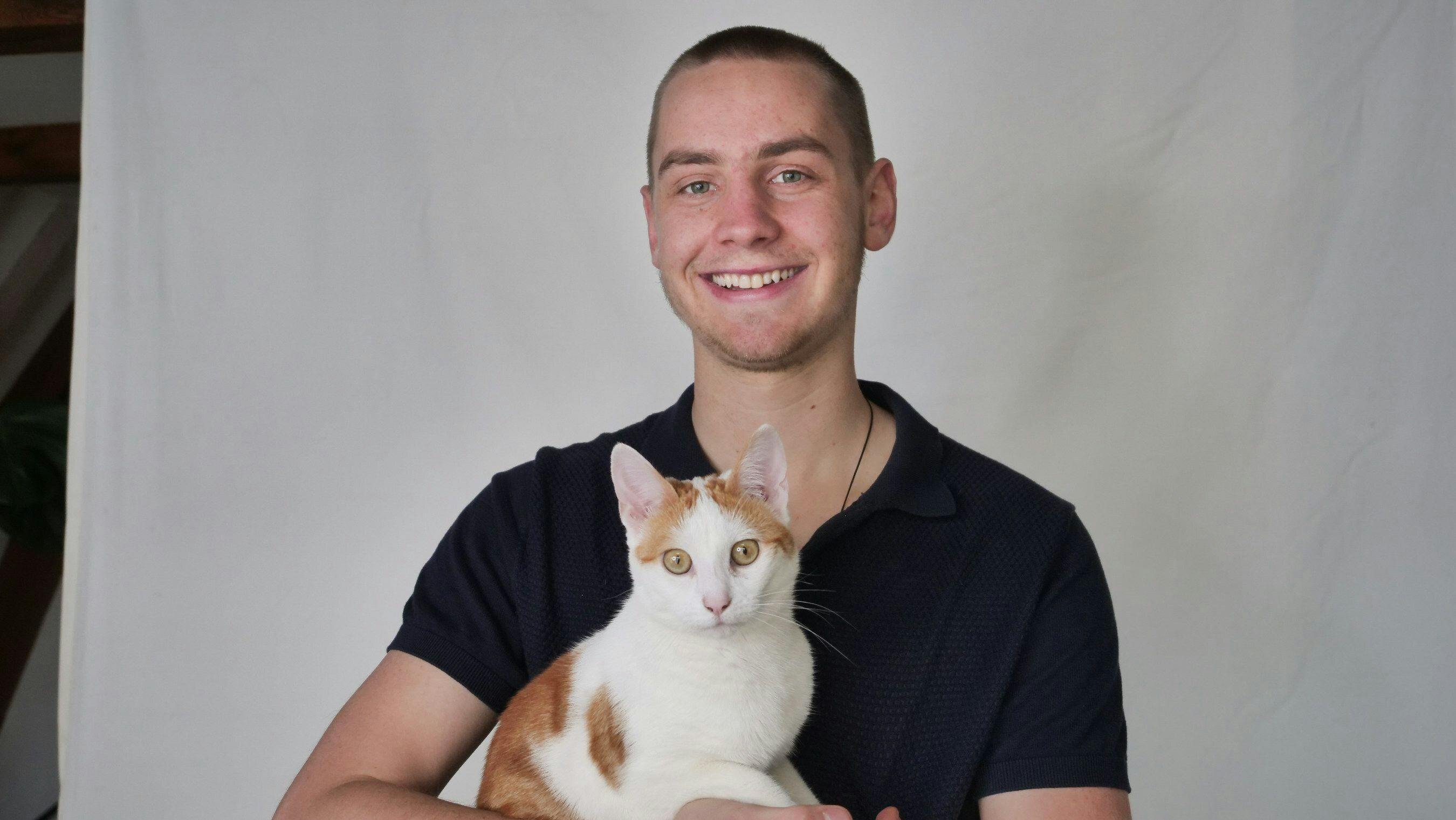 David Olthaar, founder and CEO of PetRadar, with a cat. 
