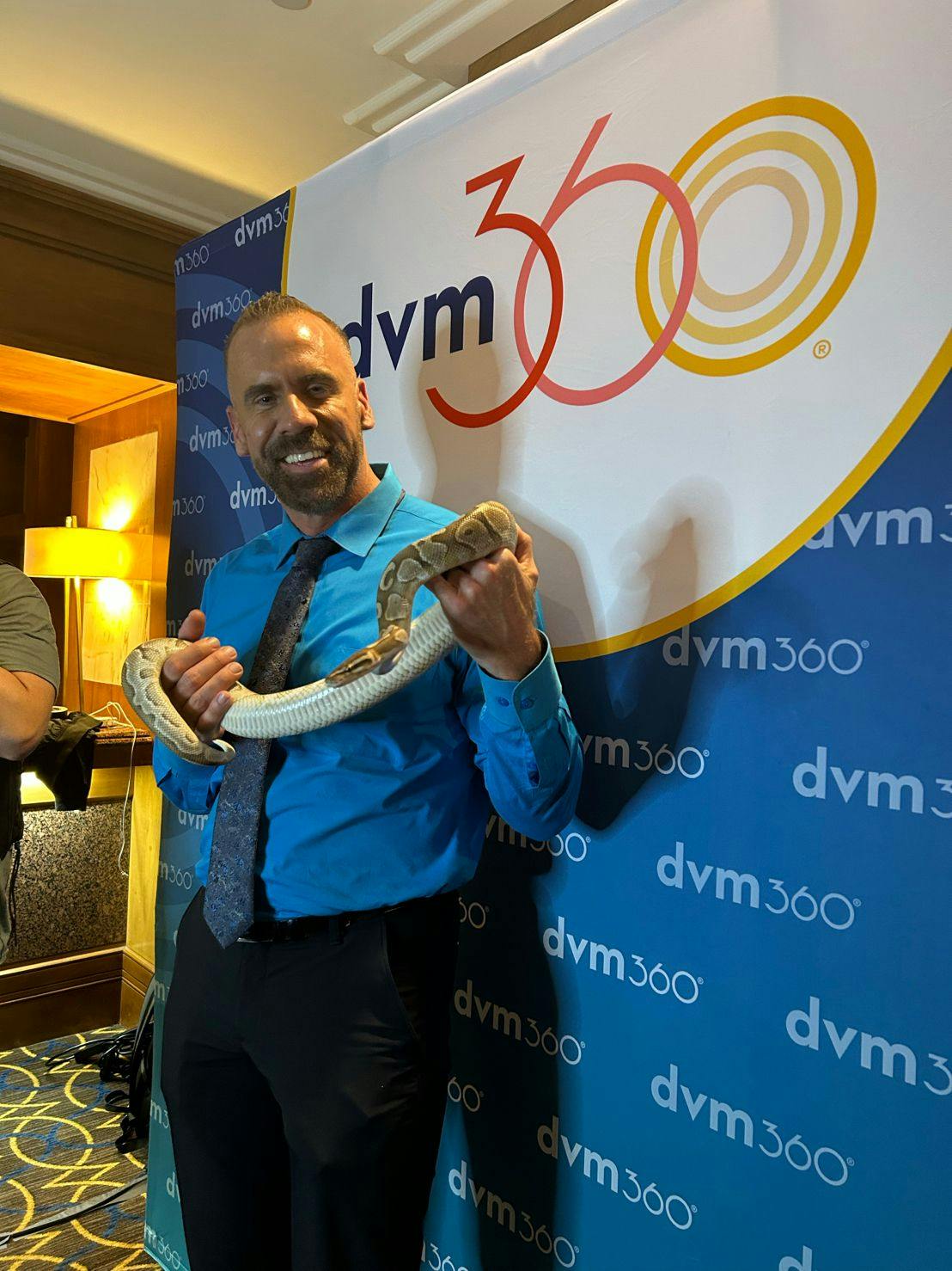 Our chief veterinary officier, Adam Christman, DVM, MBA holding a snake at the DIVM reptile reception.