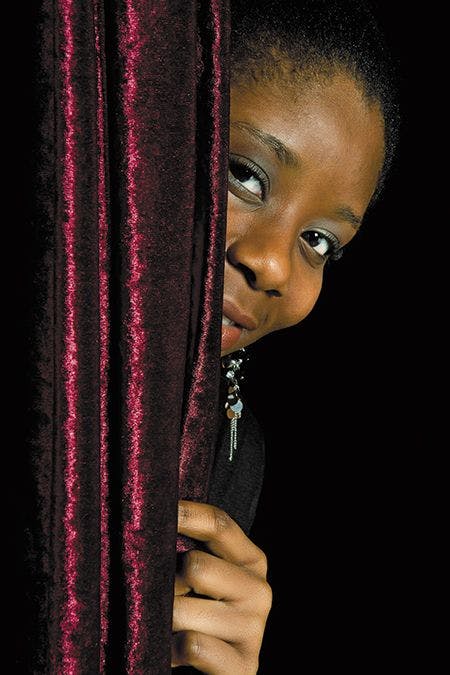 veterinary-young-african-ghanese-woman-hiding-shy-behind-a-curtain-450px-shutterstock-94896247.jpg