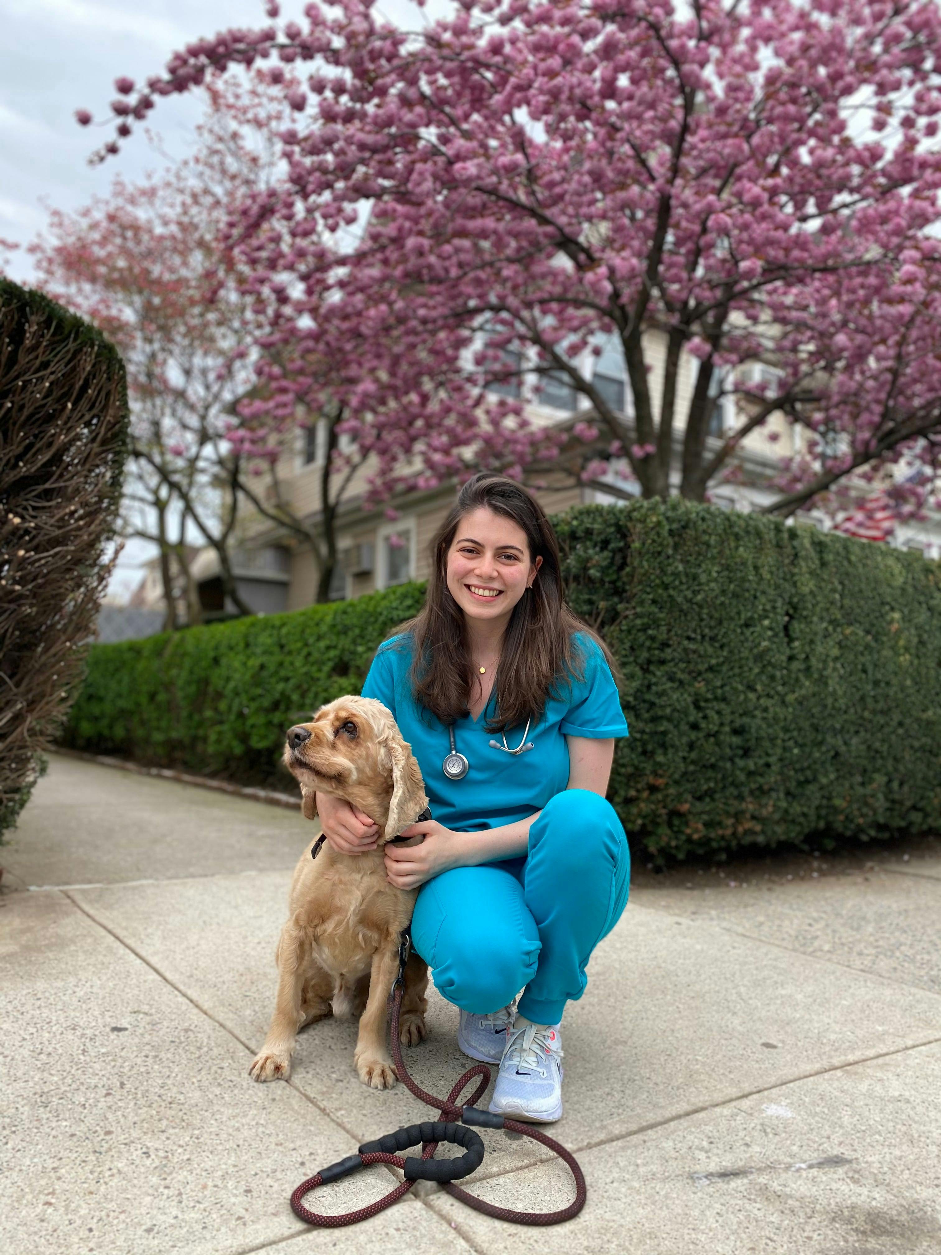 Maryna Mullerman and her family's dog, Persik, celebrating her acceptance to Cornell's College of Veterinary Medicine, in April 2021.