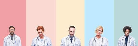 Veterinarians standing against colored backdrop