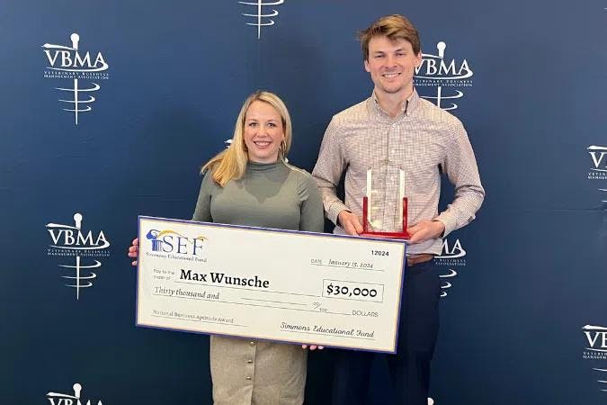 Carly Watson Tobler, chief operating officer, presents the 2024 SEF Business Aptitude Award to Max Wunsche. (Photo courtesy of Simmons & Associates)
